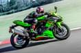 It is powered by a 399cc, 4-cyl motor making 80hp and 39Nm of torque Kawasaki Ninja ZX4RR right side profile riding image on track